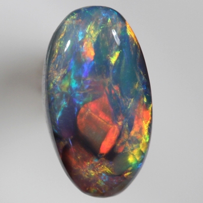SOLID BLACK OPAL Cherry red and orange over a green/blue background